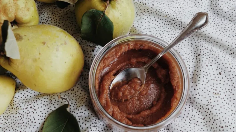 Pear fruit preserve in jar with spoon and fresh pears