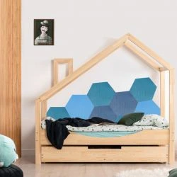 Postel s geometrickými panely sloužícími jako ochrana zdi za postel.